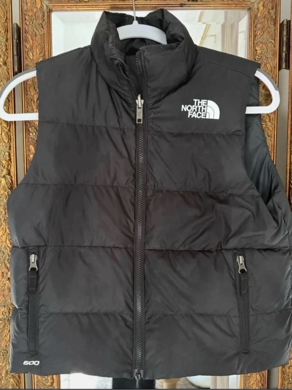 The North Face reversible 600-fill down puffer vest in classic black.Boys L